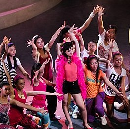 Group of actors and actresses striking their final pose in the musical FAME