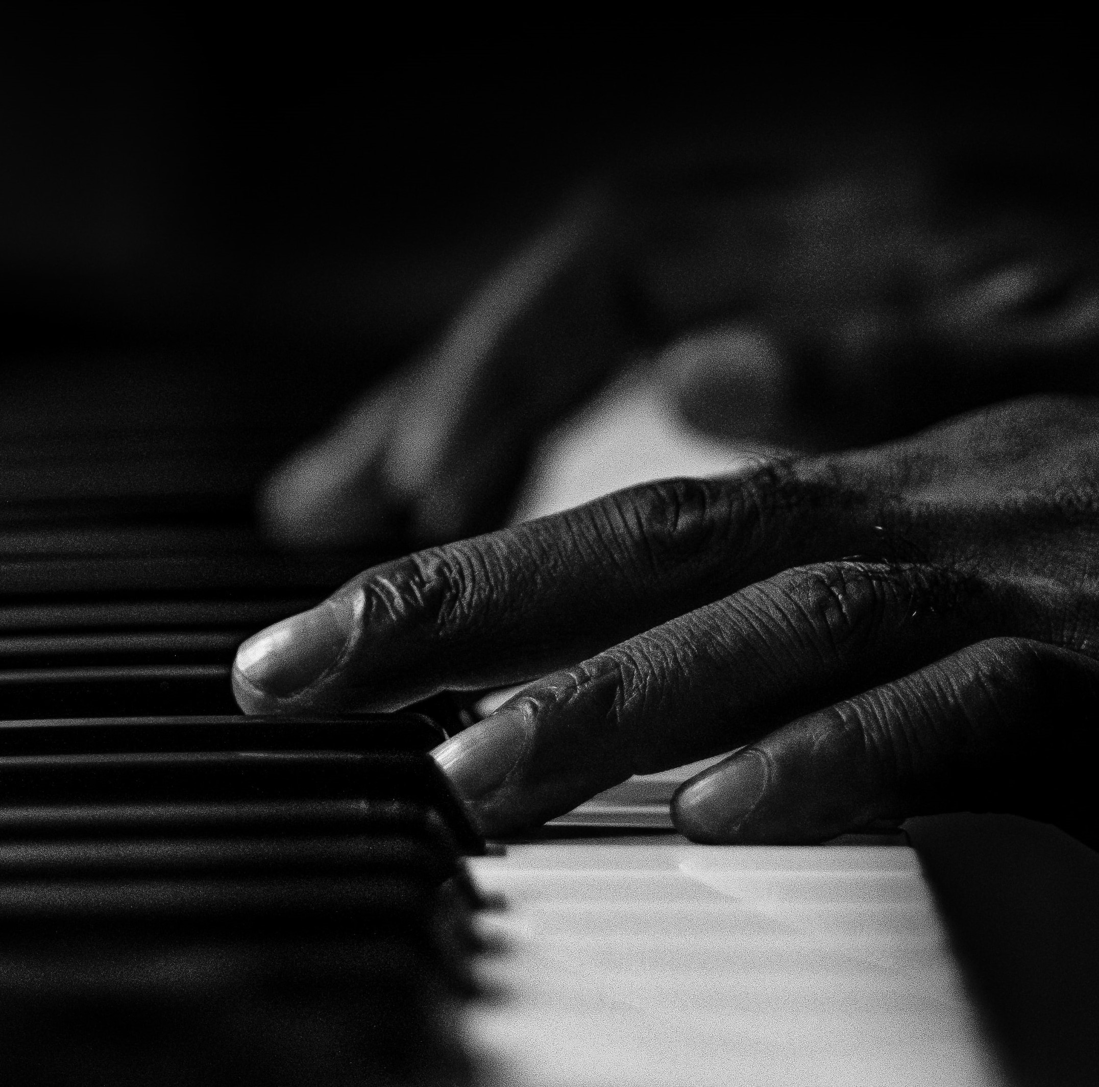 Hand touching piano keyboard